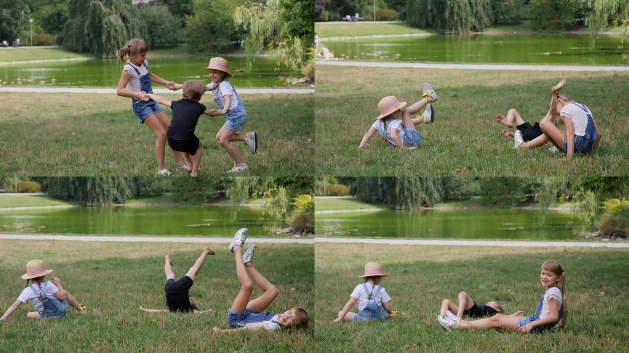 有趣的孩子在草地上摔倒在一起在公园跳舞跳跃玩得开心