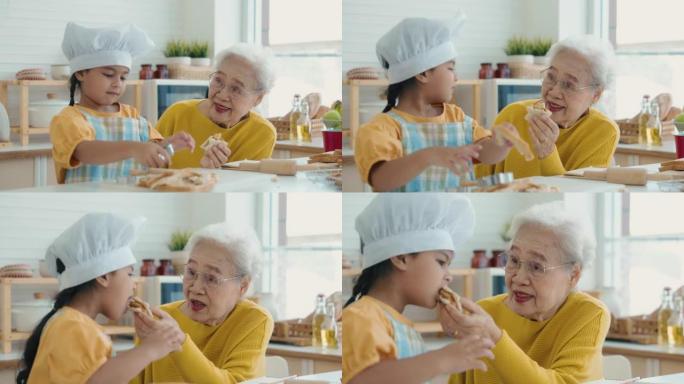 奶奶给孙女喂饼干吃饭就餐用餐祖孙