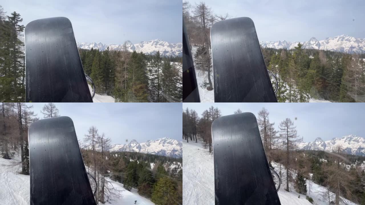滑雪缆车中的滑雪板经过高山景观