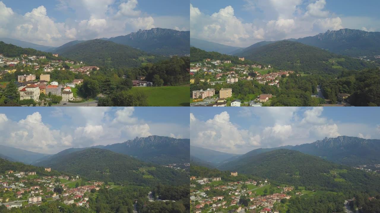 在阳光明媚的日子里，空中无人机拍摄了一个山村，山峦起伏。
