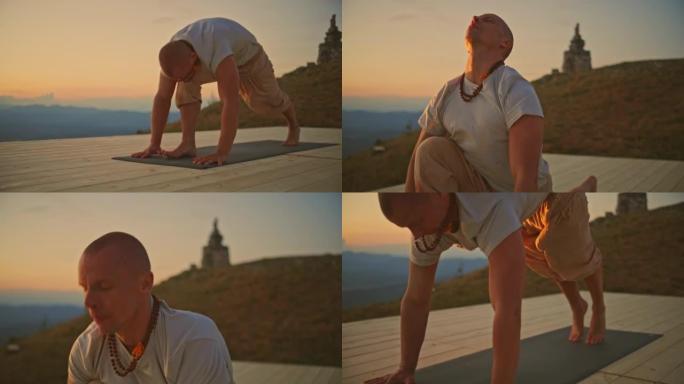 SLO MO Man在日出时在山顶上做瑜伽