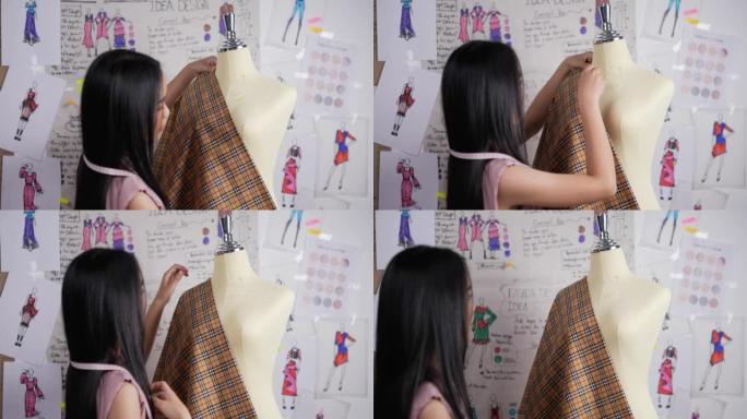 亚洲女性时装设计师穿模特服装的背景图