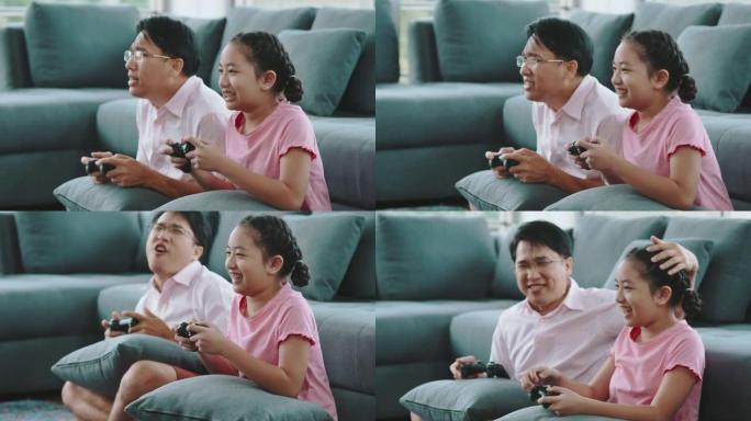 父亲和女儿一起在家玩电子游戏