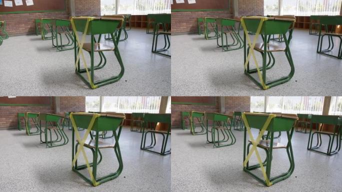 空的学前班教室标有空的课桌，以保持学生之间的社交距离