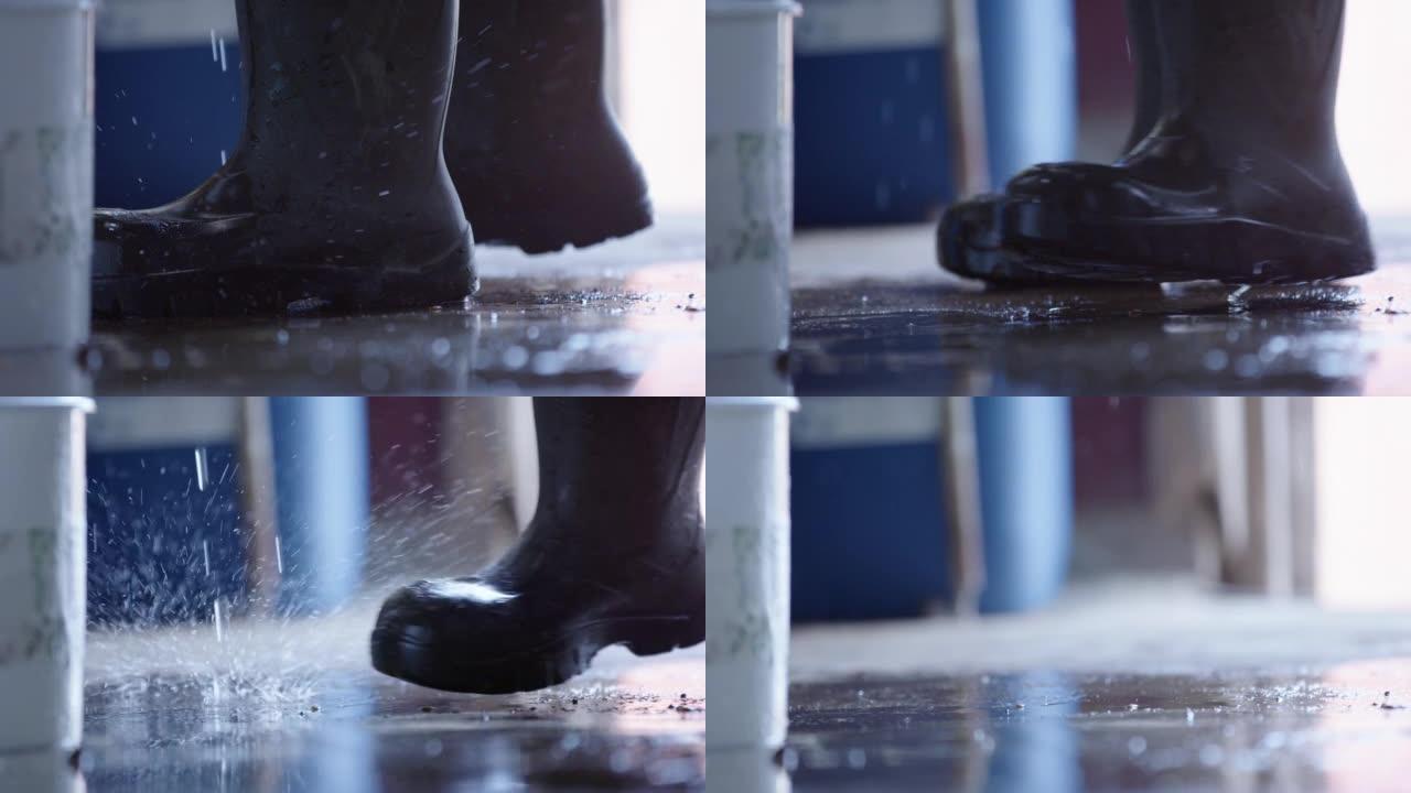 慢动作-液体溅到橡胶靴周围的地板上