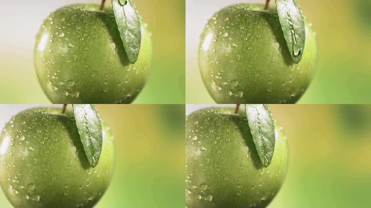 从自然背景上的青苹果叶子上落下的水滴。水疗、护肤、化妆品美容概念