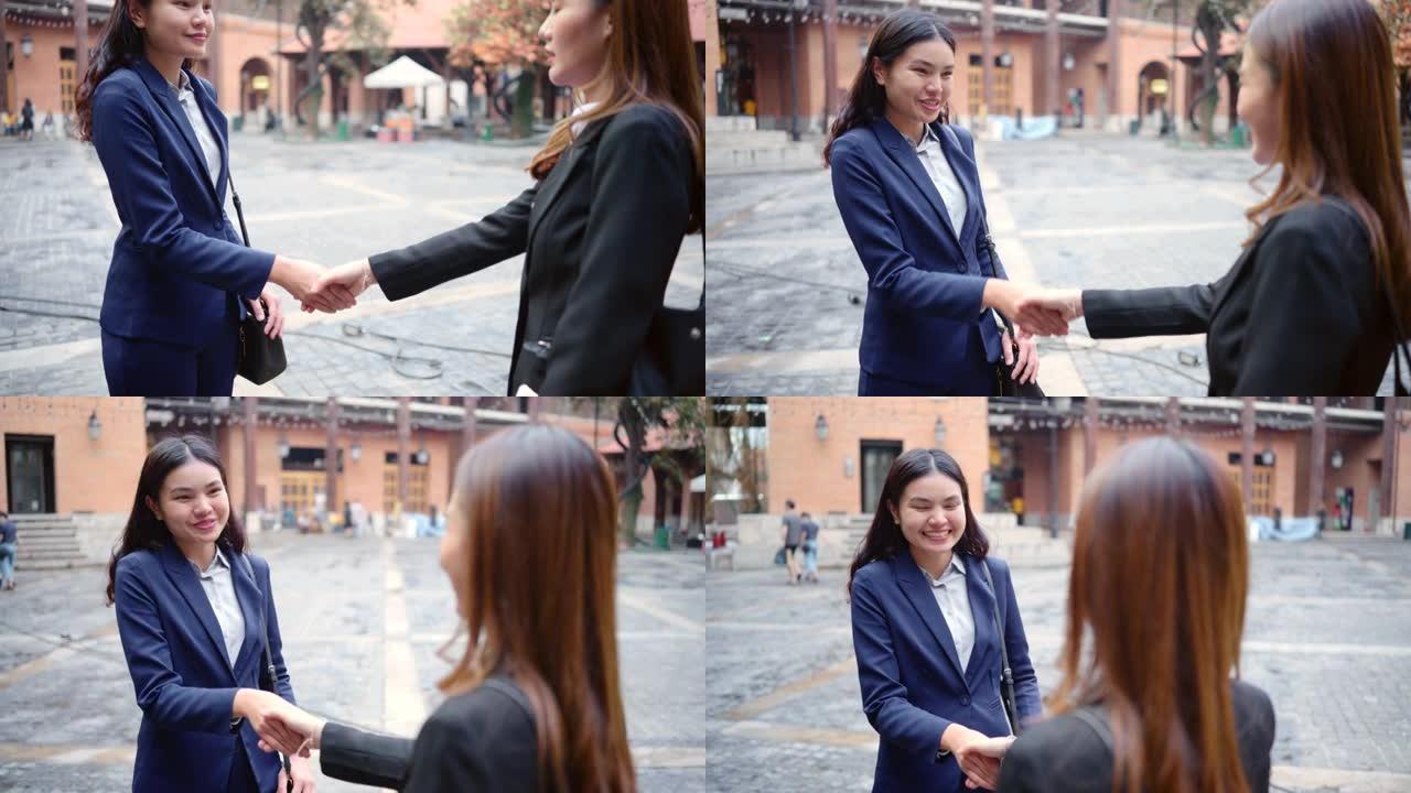 年轻的女商人在一次成功的商业谈话后握手。