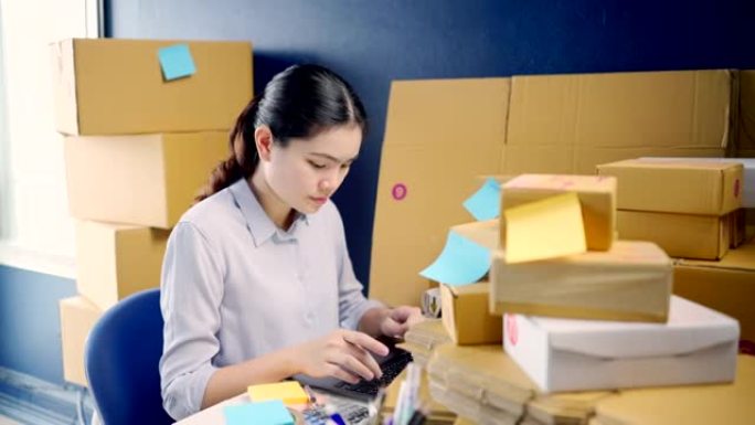 中小企业检查订单的亚洲企业主，在家工作。