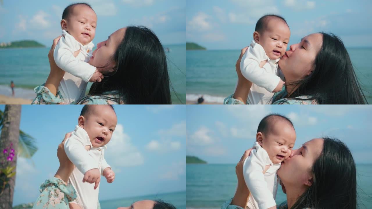 快乐的母亲和婴儿在海岸线度过浪漫的时刻。