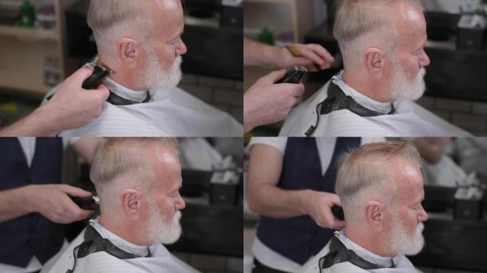 男士沙龙，一个留着胡子的老男人在时髦的理发店里用理发师剪了一个现代的发型