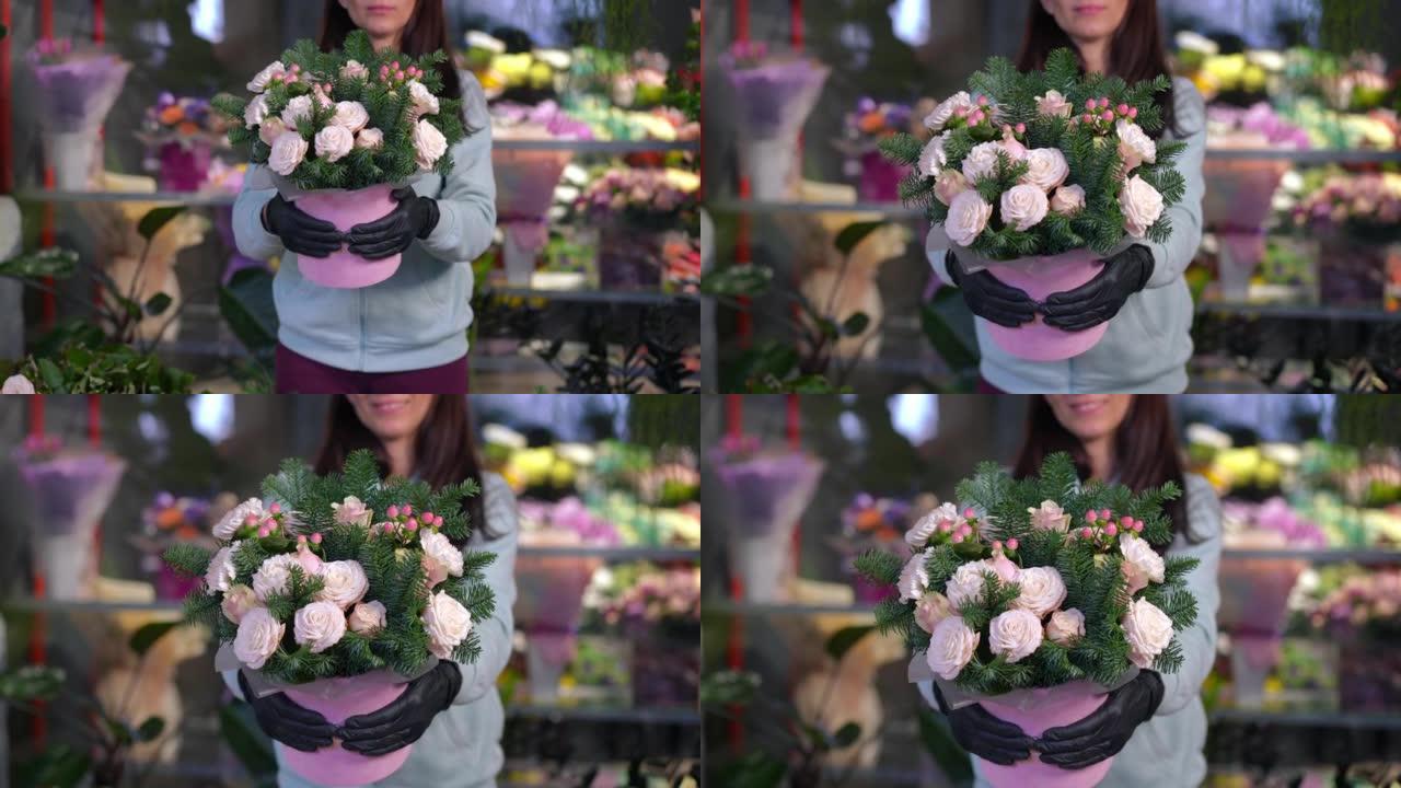前视图无法辨认的女人站在花店里，将美丽的花束伸向相机。苗条的年轻高加索女性花店在室内炫耀花朵。