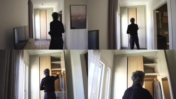 一名黑衣男子进入公寓，走向壁橱