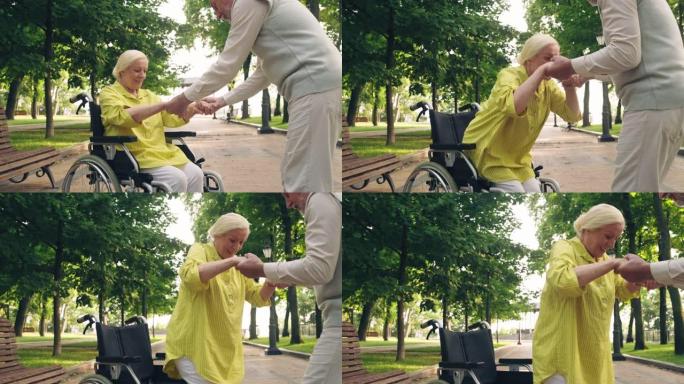 丈夫帮助残疾妻子从轮椅上站起来，照顾