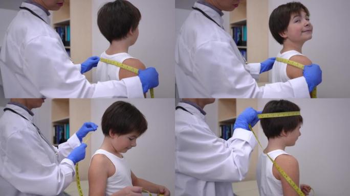 无法识别的医生在医院测量肩膀和高加索男孩的头。集中专业儿科医生在诊所室内采取儿童身体措施。