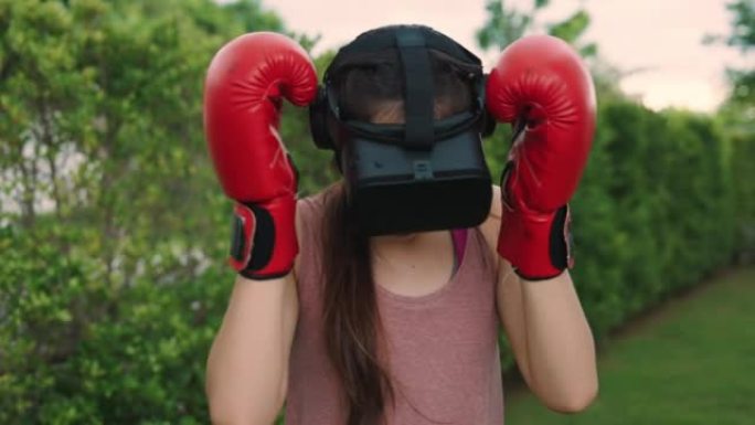 亚洲女子戴虚拟现实耳机玩拳击运动