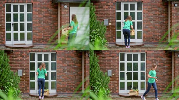 年轻女子把一个装有新鲜农产品的木箱放在家庭住宅的门口