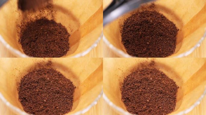 在纸过滤器中舀烘焙和研磨咖啡。