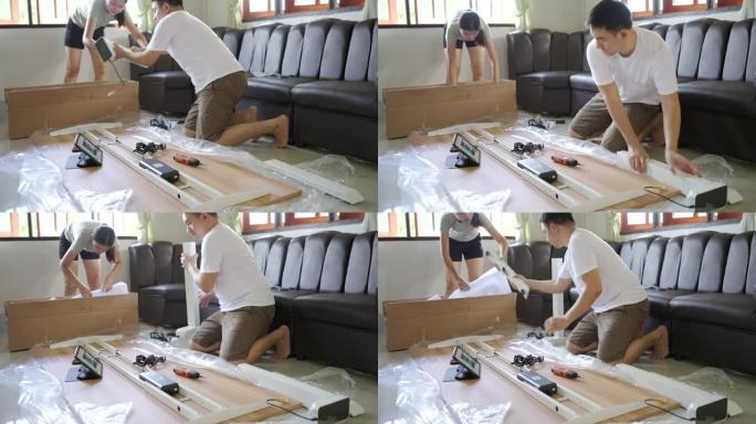 亚洲夫妇在家组装新家具。