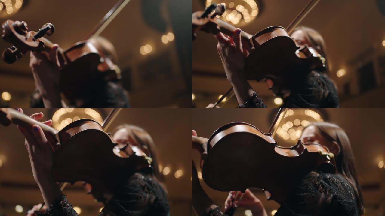 女小提琴手正在演奏音乐，旧的昂贵小提琴和女手的特写镜头