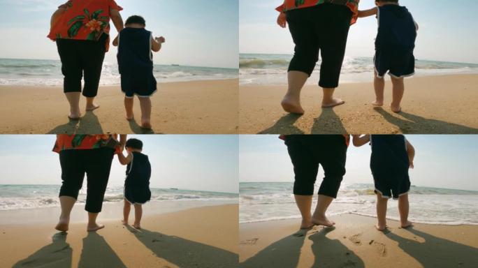 后方视图: 亚洲祖母和她的孙子在沙滩上散步很开心
