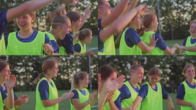 SLO MO年轻的女足球运动员在下午的练习中欢呼雀跃