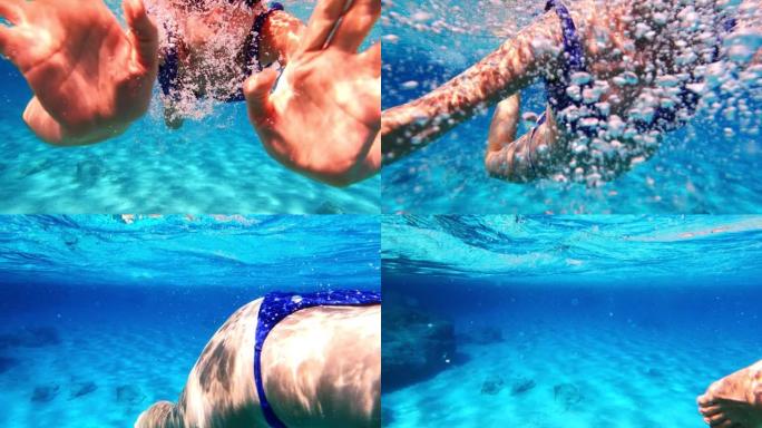 女人在海里浮潜。向可穿戴相机游泳，打手势