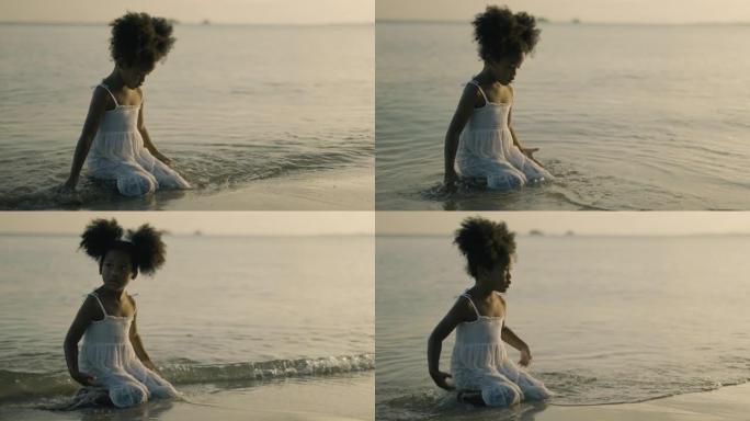 非洲女孩在海滩上玩沙子