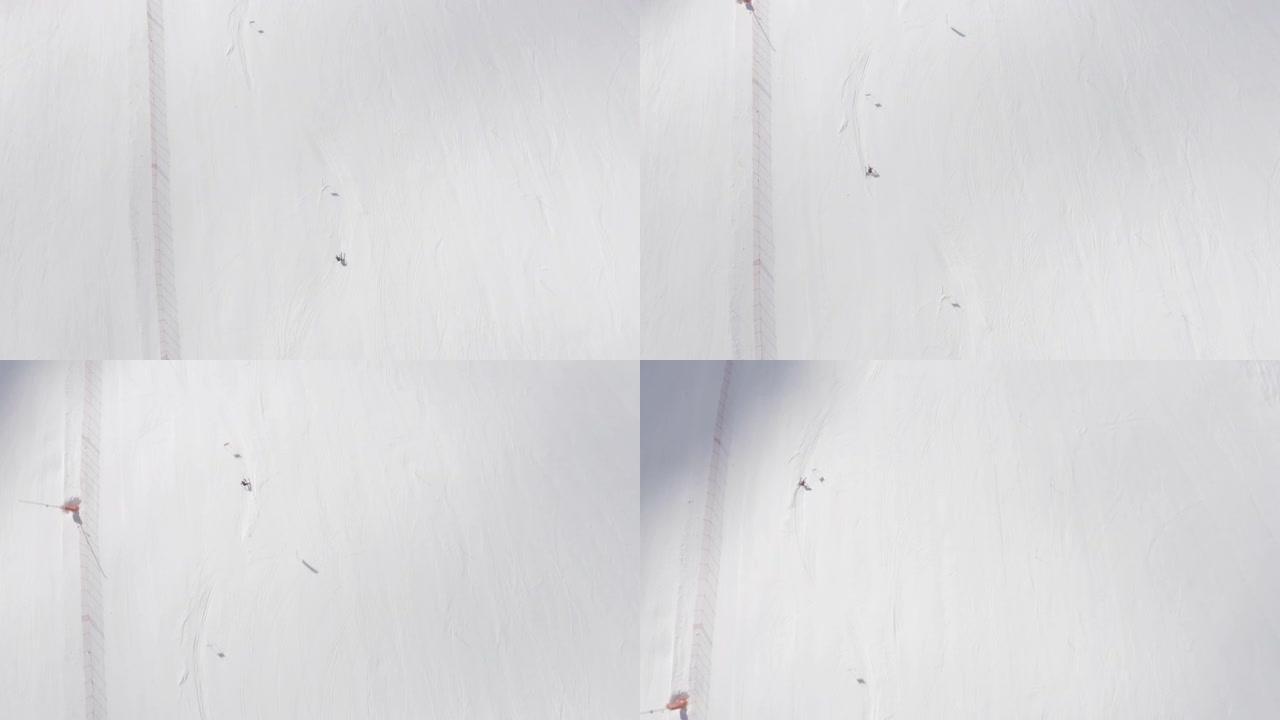 空中无人机在滑雪板上方对着新鲜的雪射击
