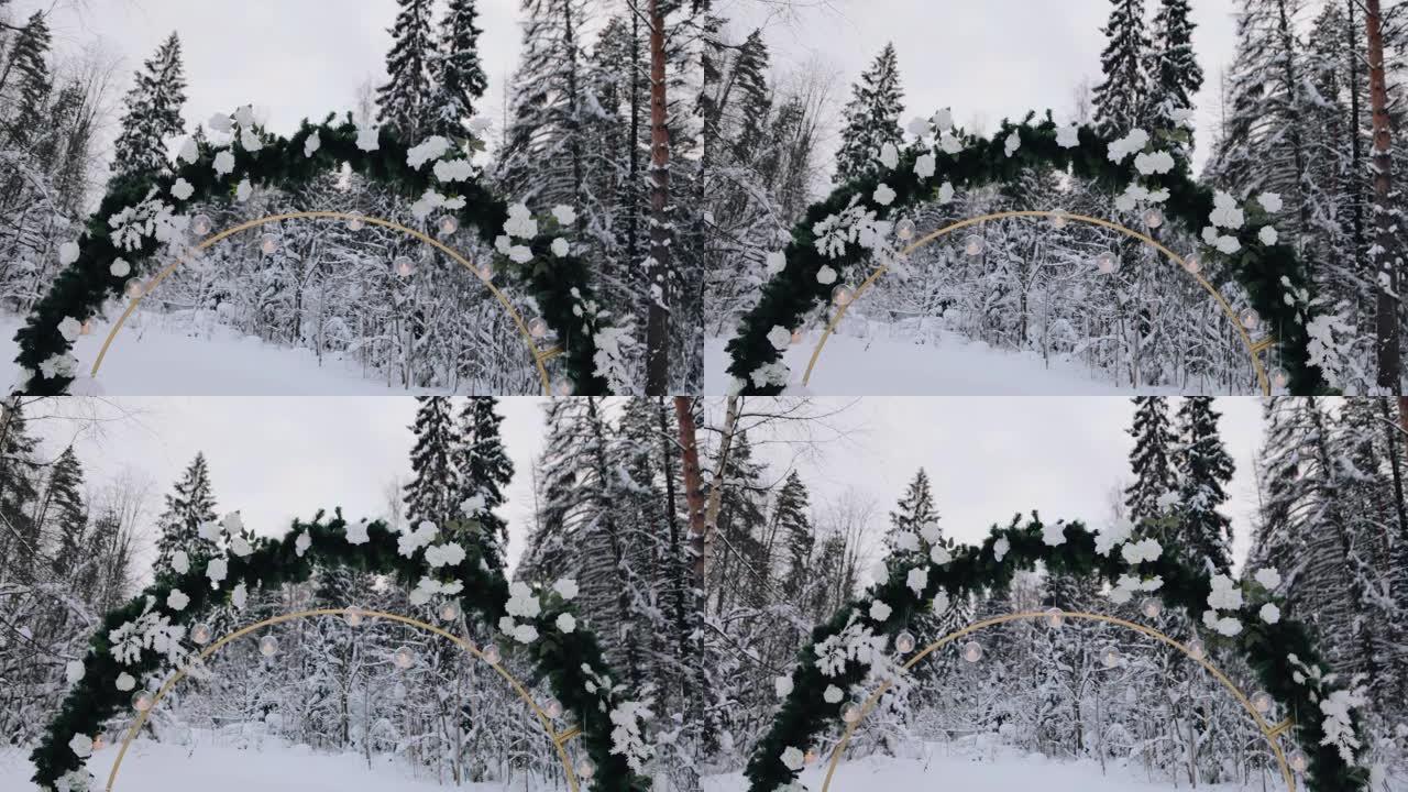 美丽的冬季婚礼拱门装饰有云杉树枝和小灯泡。平稳的摄像机运动