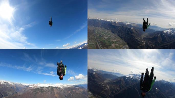 跳伞运动员降落在乡村景观上方的晴朗天空中