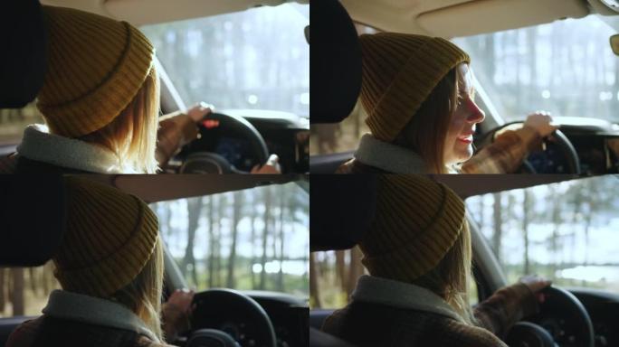 戴着帽子的mo back女司机沿着讨人喜欢的道路骑行，并在阳光下微笑