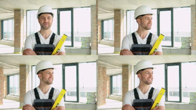 在建筑工地，一位工程师戴着黄色的头盔，手持平衡尺。气泡水平尺近距离观察，测量和水准概念