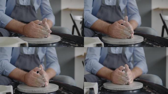 一名男性陶工的手在慢动作中制作陶瓷板的特写镜头