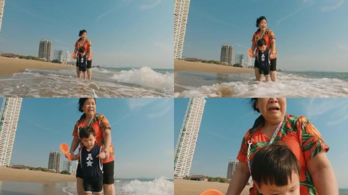 快乐的亚洲家庭在漫长的周末在海滩上享受时光。