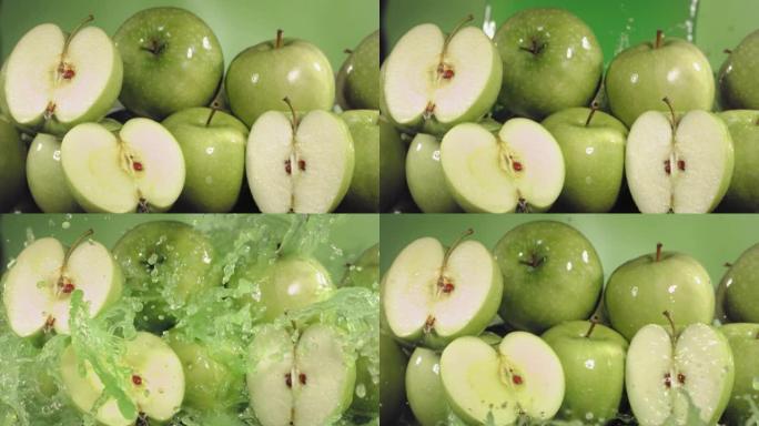 绿色苹果汁溅过苹果片的慢动作镜头