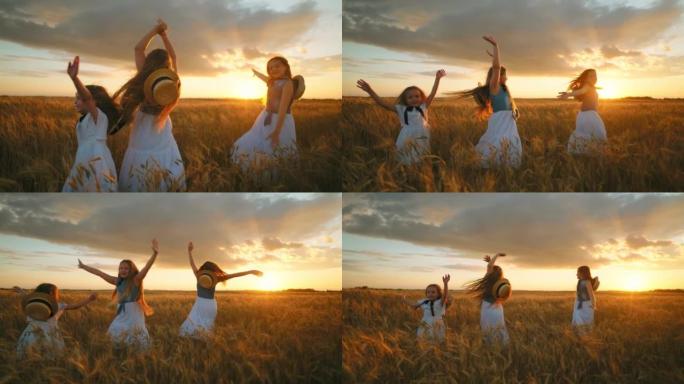 快乐的斯拉夫儿童女孩在日落的农田里的金色黑麦田上旋转，小姐妹们