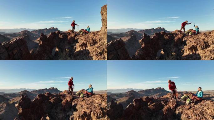成熟的登山夫妇攀登后在山脊上休息