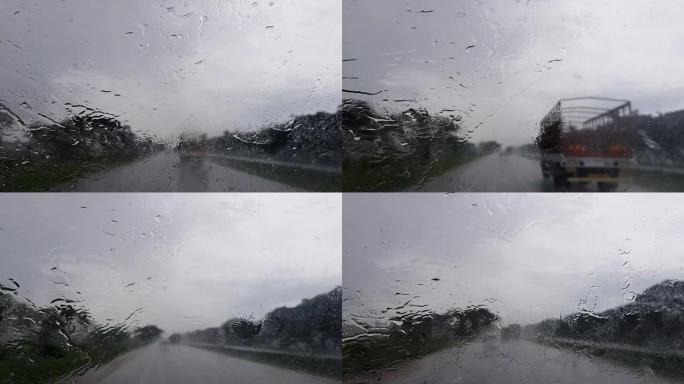 雨中在高速公路上行驶，刮水器在磨砂挡风玻璃上，白天能见度很差