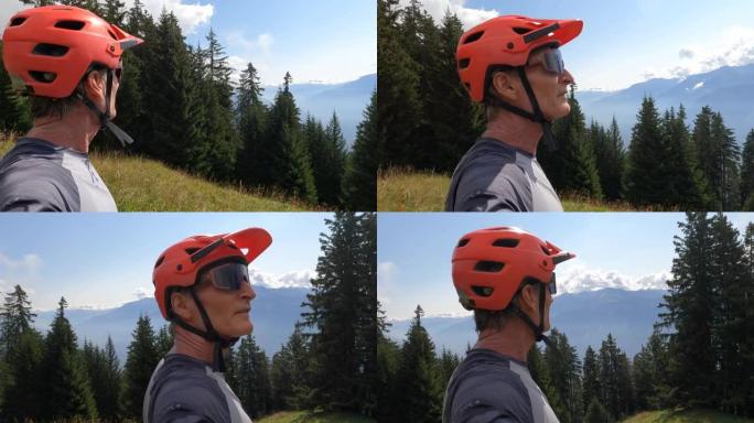 男性骑自行车的人停下来欣赏群山美景