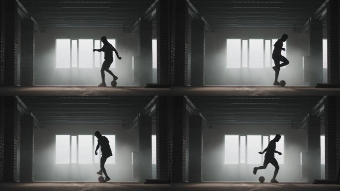 非裔美国足球运动员在空有盖的停车场内练习踢球和移动。慢动作黑人在阳光下在地下公园运球。