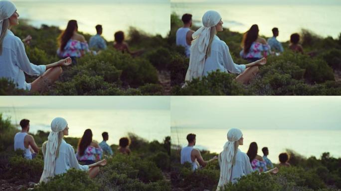 一群不同的朋友坐在草崖上，一起放松。在莲花位置冥想