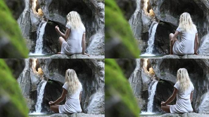 年轻女子在岩石上放松，进行瑜伽动作