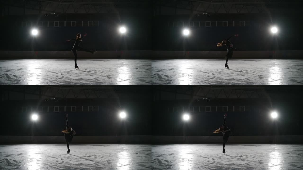 溜冰者在室内溜冰场训练。在体育场进行花样滑冰。这个年轻的女孩表演花样滑冰，后退旋转的元素。