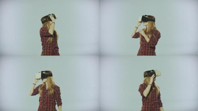 在中性背景下体验VR虚拟现实的女人