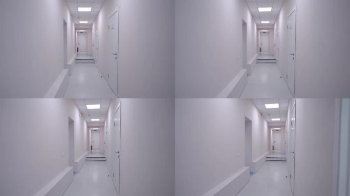 没有人的白色诊所走廊的照片。宽镜头清洁现代医院走廊室内无人。