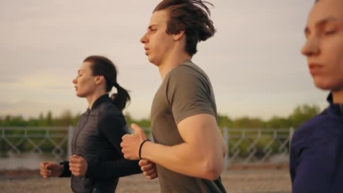 年轻男子和两个女人夏天一起跑步，训练和慢跑