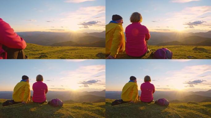日落时分坐在山顶上的SLO MO CS高级徒步旅行夫妇