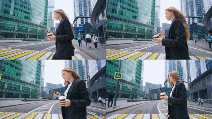 一位女商人走在城市的人行横道上，查看智能手机上的通知