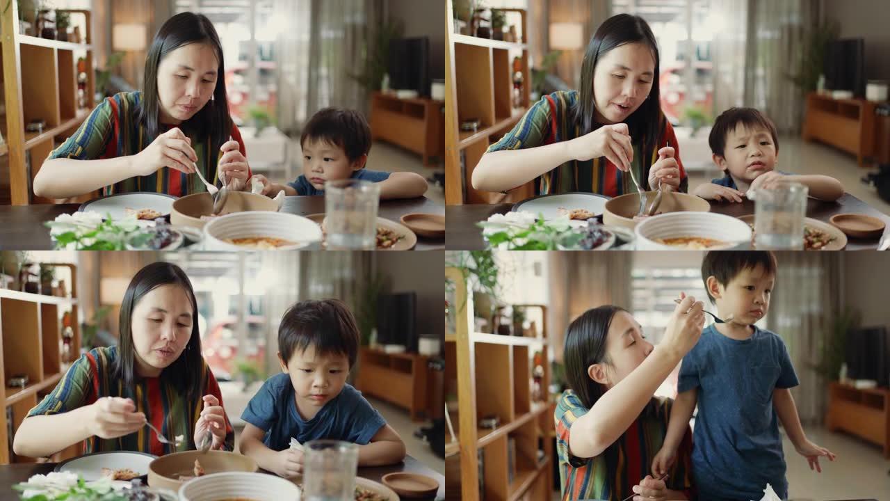 快乐的亚洲家庭在家吃泰国菜。