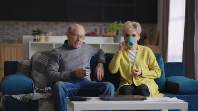 平静的已婚夫妇周末在家休息，奶奶和爷爷在公寓客厅喝茶